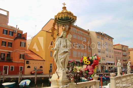 Picture of Statue of the Blessed Virgin Mary and Christ child on a canal in Chioggia North Italy Europe